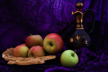 Apples in a wooden plate and vintage jug. Still life photography. 