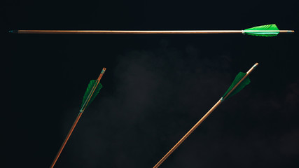Three wood arrow one flying . Beautiful  smog background. Medieval weapons are handmade.
