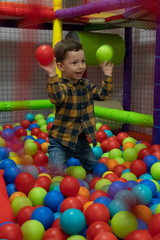 Two years old boy playing in a ball park