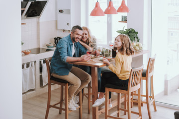 Happy family spending time together and enjoying dinner at home