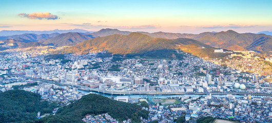 Business concept, modern cityscape of nagasaki dusk from mount inasa, the new top 3 nightview of the world, aerial view, copy space