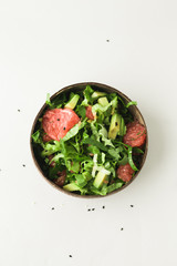 healthy green vegan salad in coconut bowl