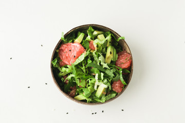 healthy green vegan salad in coconut bowl