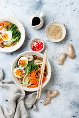 Ramen traditional japanese noodle soup with eggs, pak choi cabbage, meat broth, carrot, mushrooms...