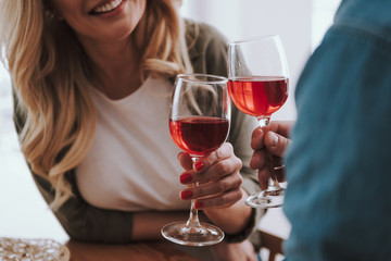Loving couple toasting with glasses of red wine at home