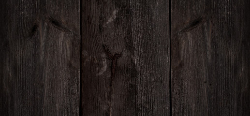Natural aging of wood. Old wood texture for the background, tinted. Wooden boards with knots and scratches.