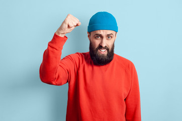 Young emotional bearded man and facial expression concept