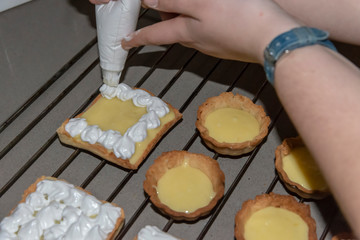 Decorating lemon pies with meringue