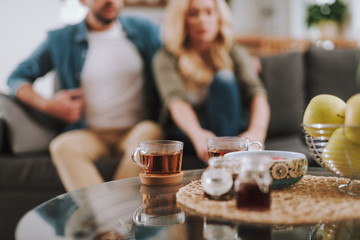 Glass cup of delicious hot beverage locating on table