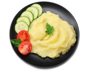 Mashed potatoes on black plate isolated on white background. top view.