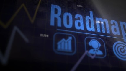 Roadmap business concept on a flashing computer monitor with moving graphs and data.