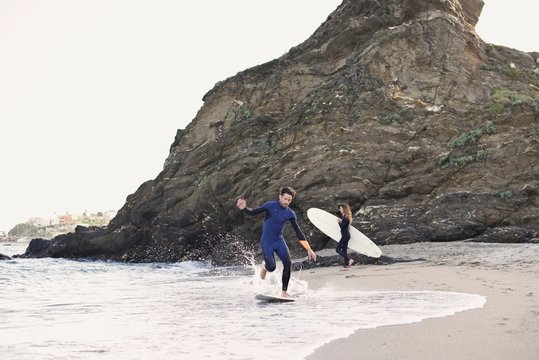 Caucasian man skim boarding at the beach
