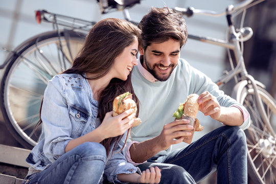 Couple Eating  Sandwiches Outdoors