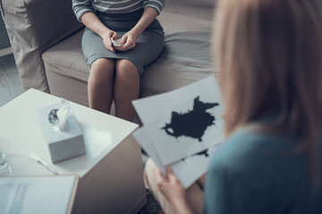 Doctor looking at Ink blot test results indoors