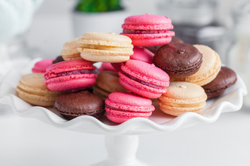 pink and chocolate macaroons on a white plate