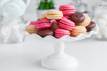 pink and chocolate macaroons on a white plate