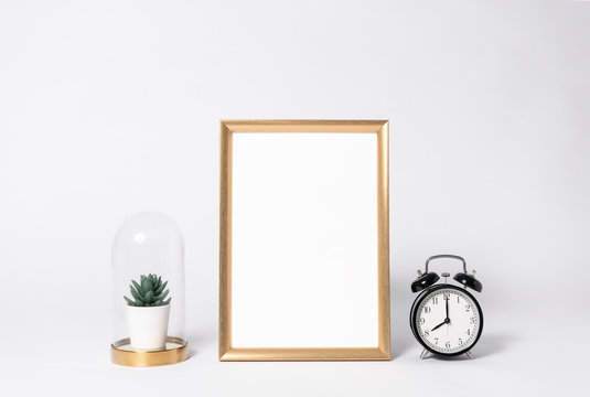 golden photo frame mock up and clock Interior decor home elements.