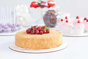 sponge cake with strawberries on white background