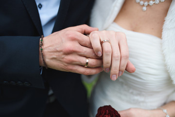 groom holding bride's hand
