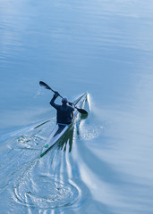 Sportsman rowing alone in a kayak