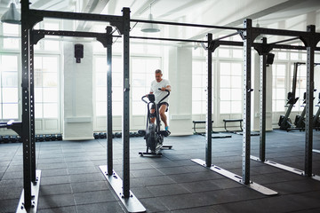 Mature man working out on a health club stationary bike