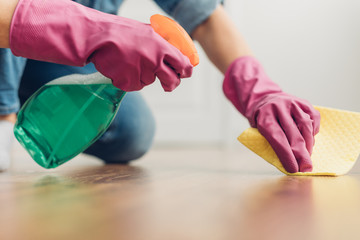 Woman trying to clean floor surface at home