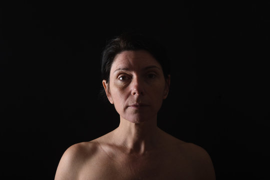 Portrait Of Middle Aged Woman On Black Background