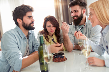 Group of friends celebrating birthday at home