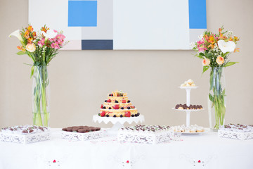 table with cake,  sweets and flowers