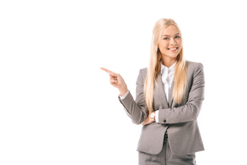 attractive blonde businesswoman smiling and showing something isolated on white