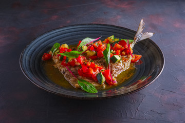 Fried fish with lemon sauce and fresh vegetables