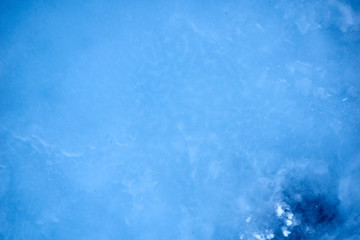 Texture blue cosmic ice with a matte effect on a river in the mountains.