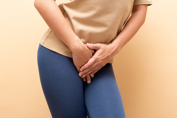 Closeup sick woman with hands holding pressing her crotch isolated on background