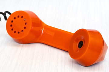 Orange phone receiver close-up