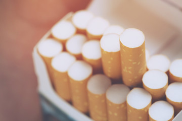 peel it off Cigarette pack prepare smoking a cigarette. Packing line up.  photo filters Natural light. soft focus.