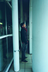 Young man alone in a bus station at night