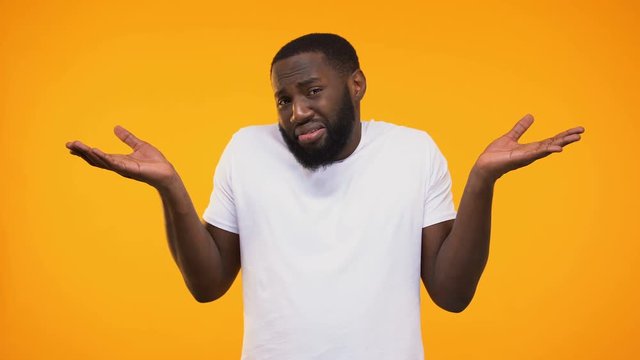 Confused African American Person Showing Do Not Know Gesture And Shrugging