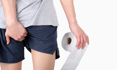 Close-up of hand is holds toilet paper roll before entering the toilet and holding the ass of...