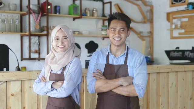 Portrait of two young freelancer smiling pose in front of the camera