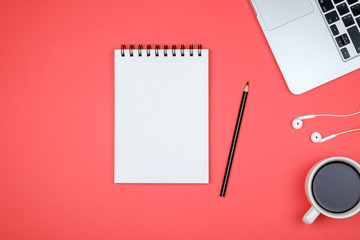 Minimal workplace with laptop and blank notepad