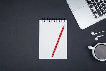 Modern office desk table with laptop and blank notebook page