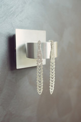luxury earrings on silver lamp
