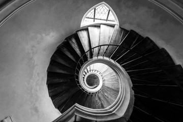 Old spiral staircase. View from above. Black and white.
