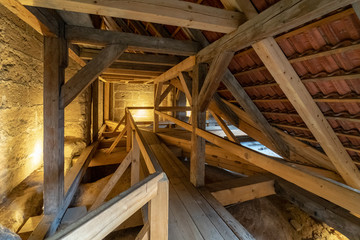 Fototapeta na wymiar Wooden structures (rafters and beams) of the attic of an old house.