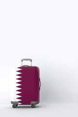 Travel suitcase with the flag of Qatar. Holiday destination. 3D Render