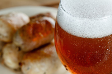 Traditional homemade sausage with beer on wooden table