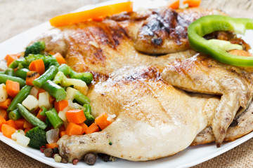 Chicken fried with vegetables on a napkin of burlap