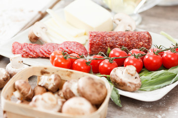Food ingredients for pizza on table
