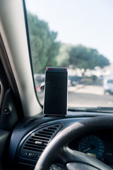 Closeup on handsfree car smartphone assistance, communication gps navigation system background....