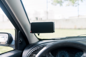 Closeup on handsfree car smartphone assistance, communication gps navigation system background....